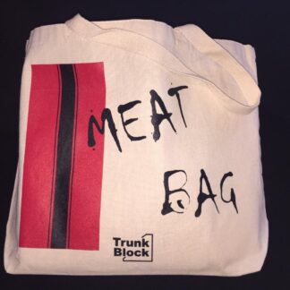 Canvas bag with red and black racing stripes on one side and the words Meat Bag in black splatter font.